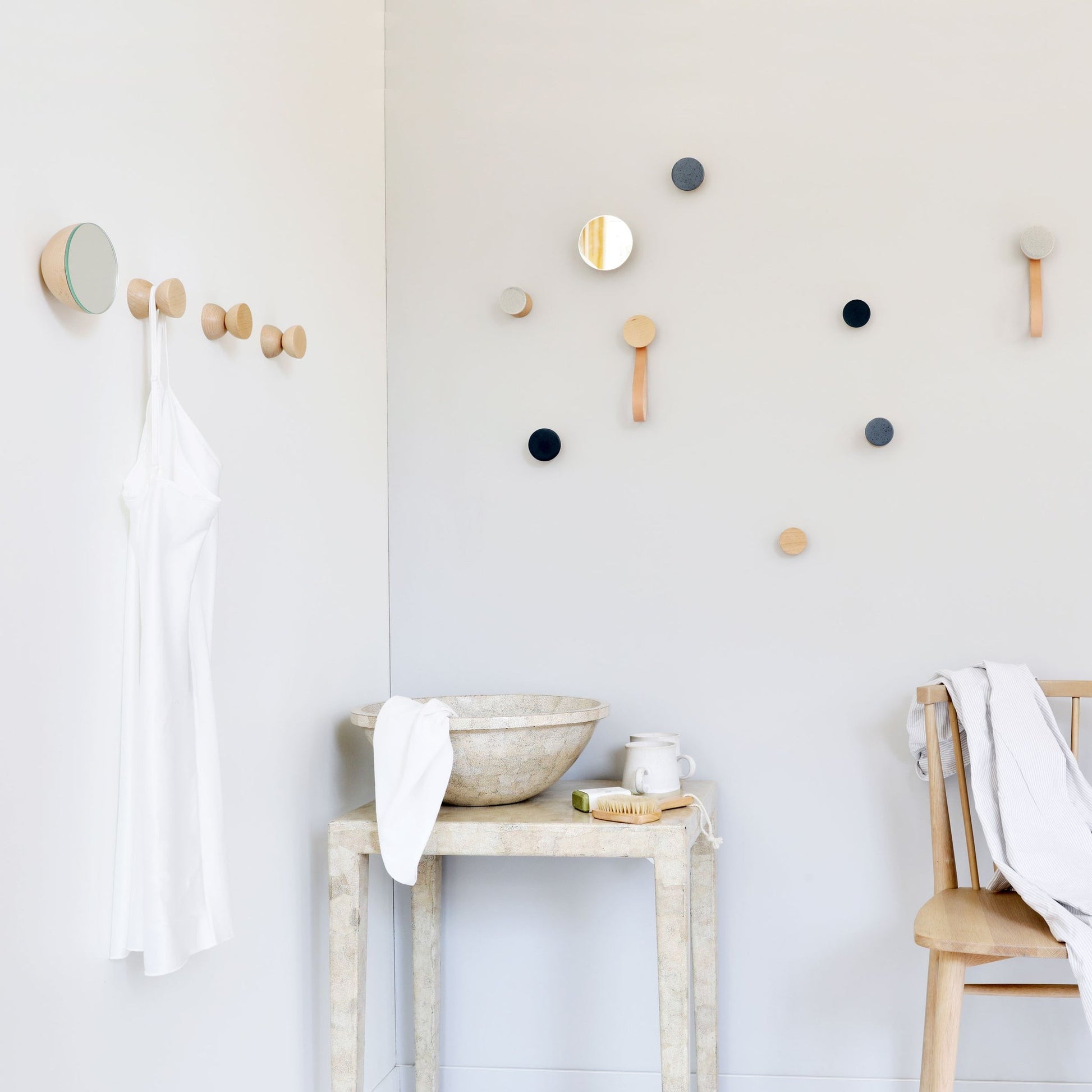 elegant grey sand ceramic and beech wood wall hook in soft light