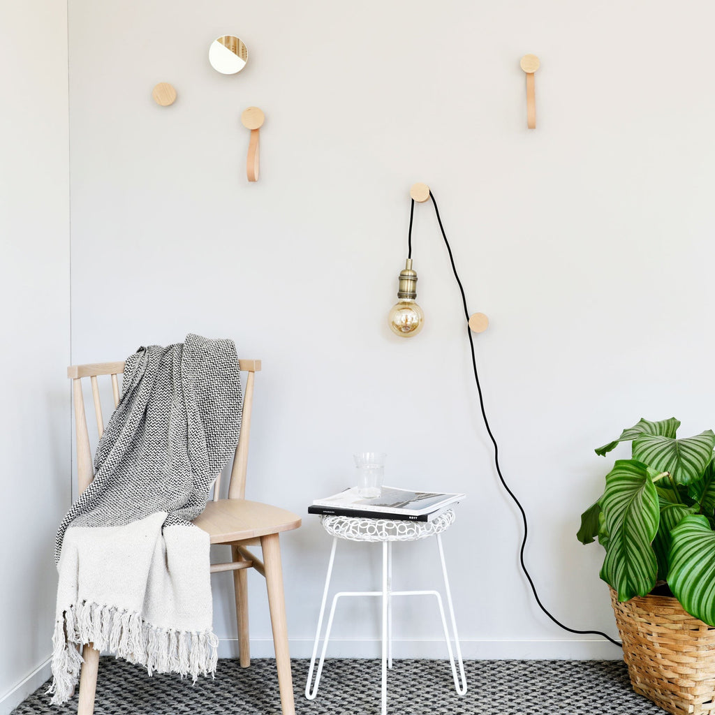 elegant beech wood wall hook in soft light highlighting its refined geometric curves and warm wood grain