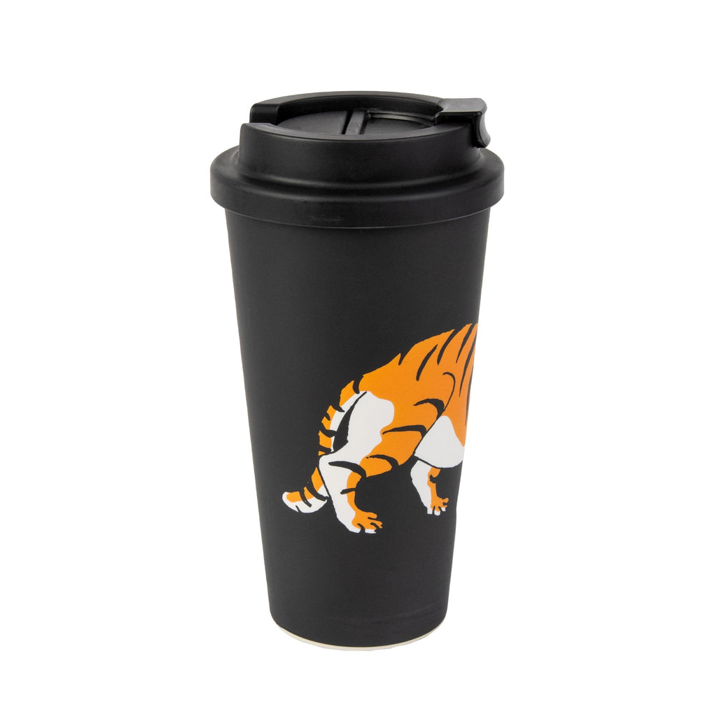 moomin character playfully peeking from a black eco coffee mug with a bright yellow background