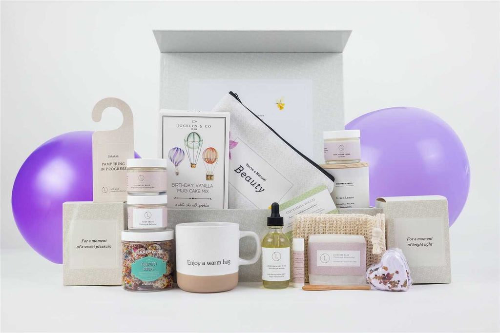 close-up of the birthday pampering gift set's ceramic mug and lavender shea butter on a rustic wooden table