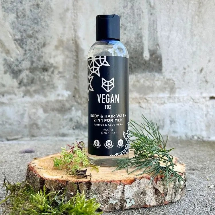 confident man holding vegan fox 2-in-1 body and hair wash with bold forest scent