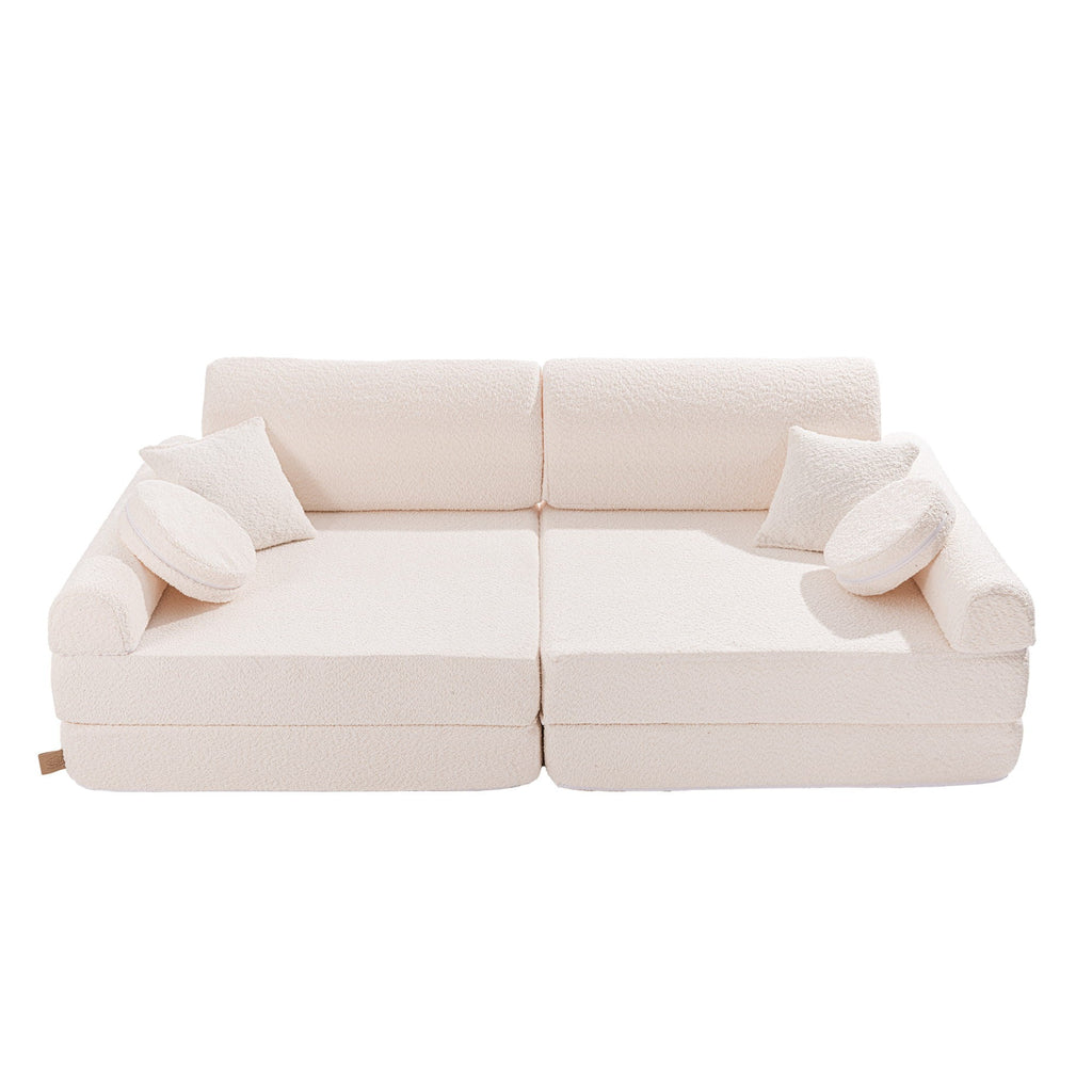 a functional large white boucle kids sofa with ottomans arranged as a play station