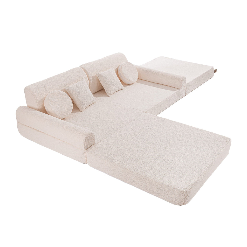 a playful kids sofa fort built from soft white boucle modules