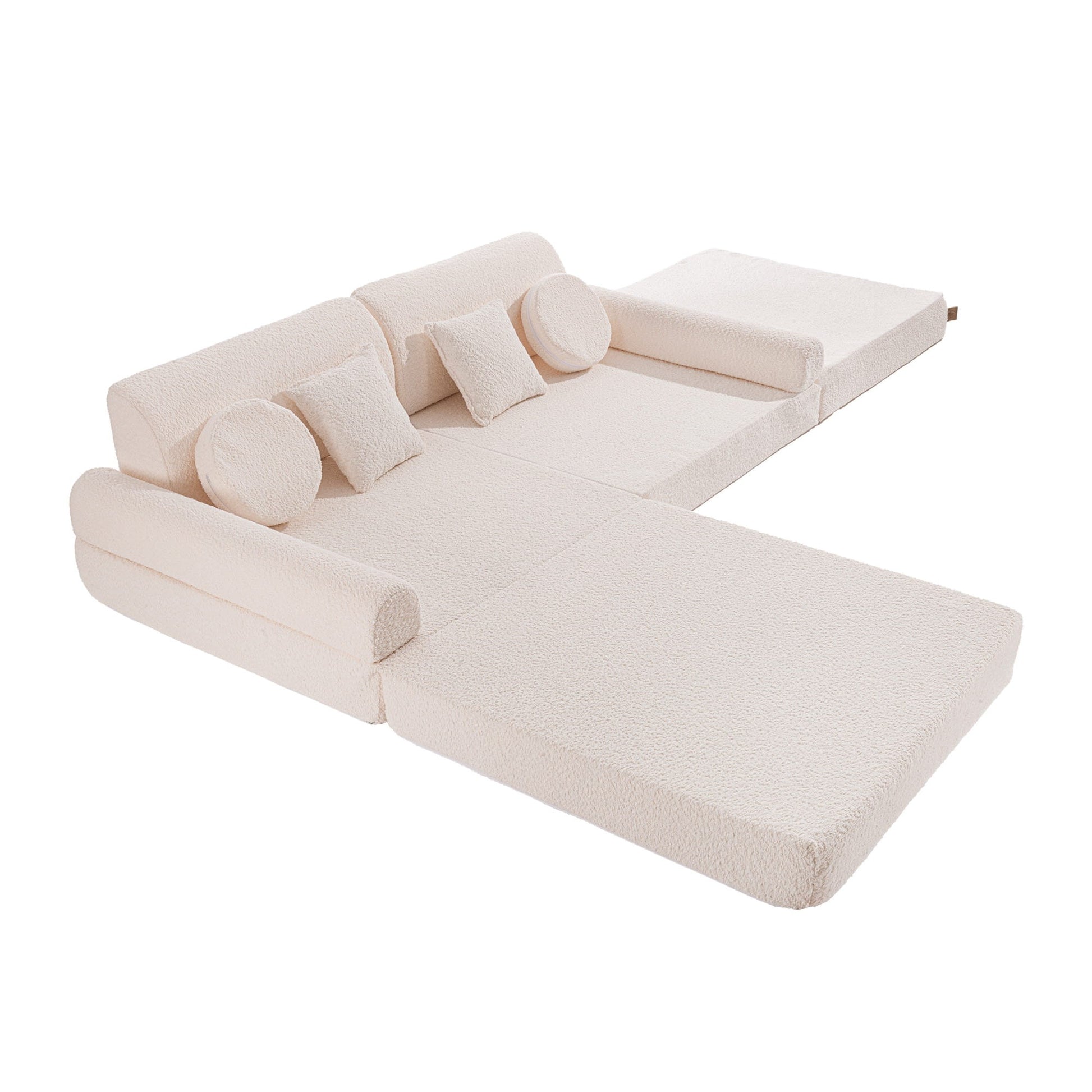 a playful kids sofa fort built from soft white boucle modules
