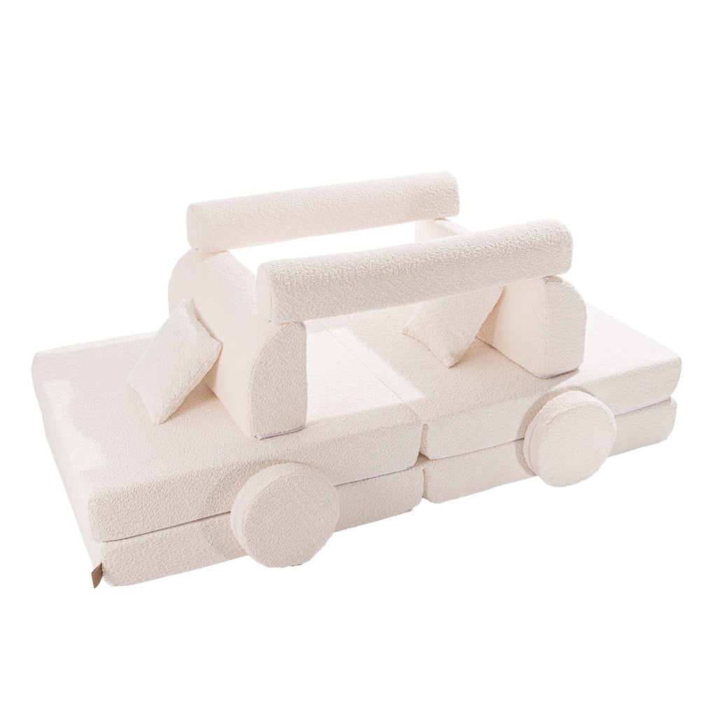 a refined white boucle kids sofa arranged in a clean, minimalist living space