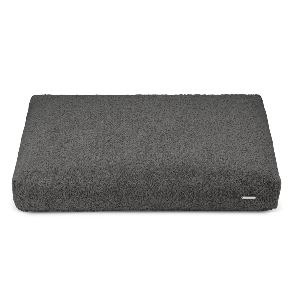 a soft anthracite grey dog cushion with a deep 3d texture, inviting comfort on a cozy sofa