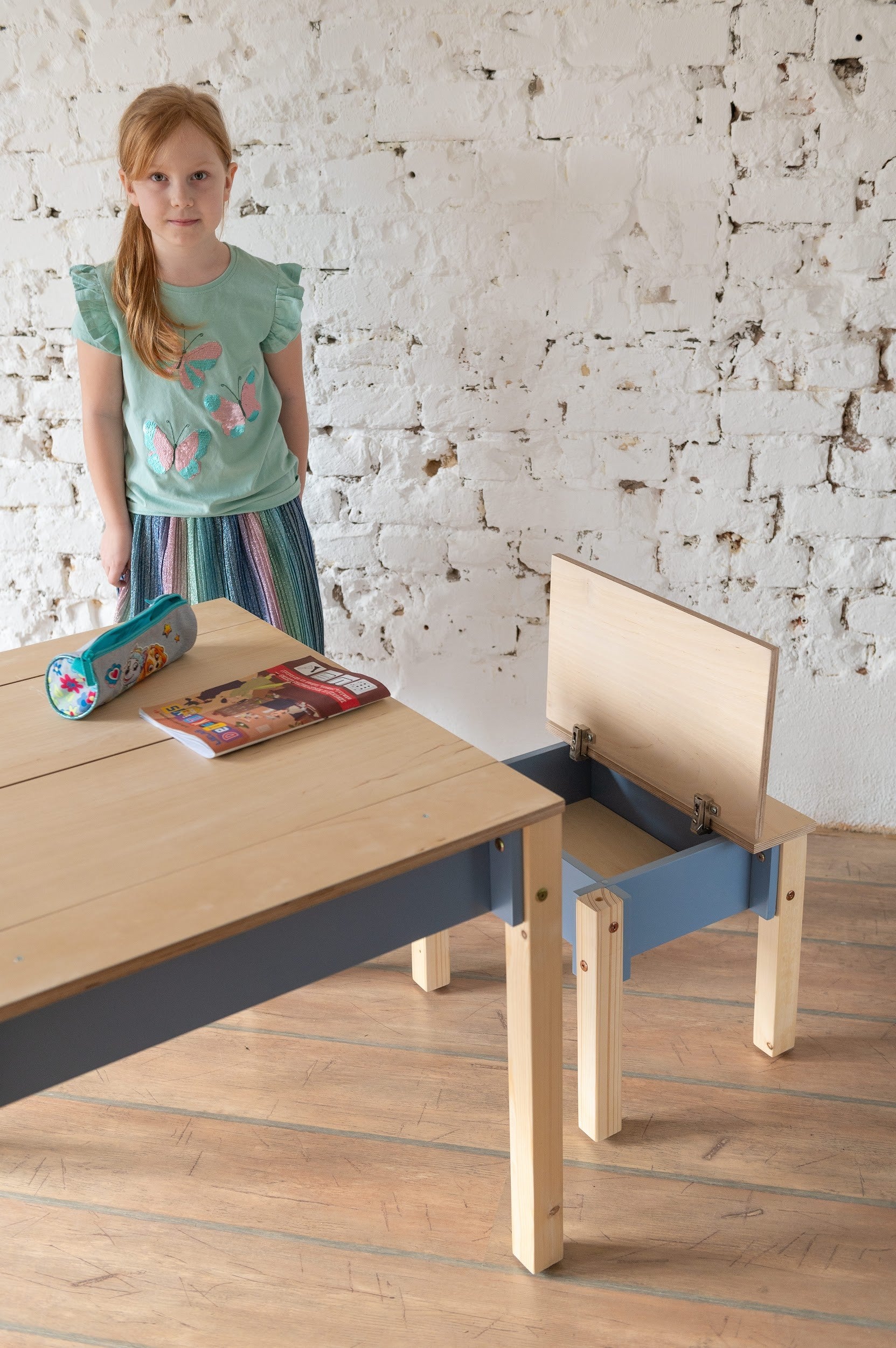 a functional kids table and chair set with built-in storage compartments for a tidy playroom