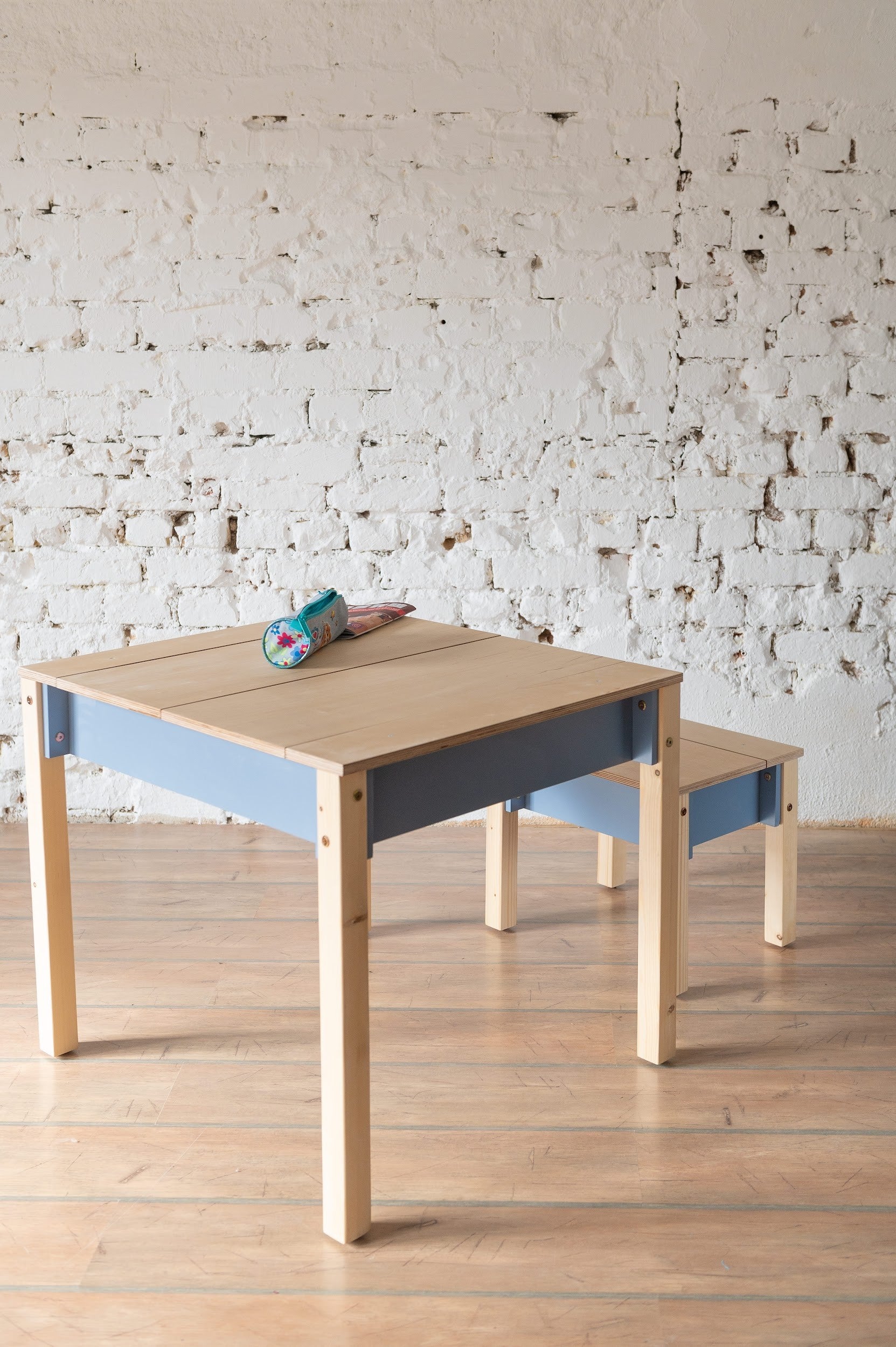 a child's compact birch chair with a hidden storage drawer open in a cozy room