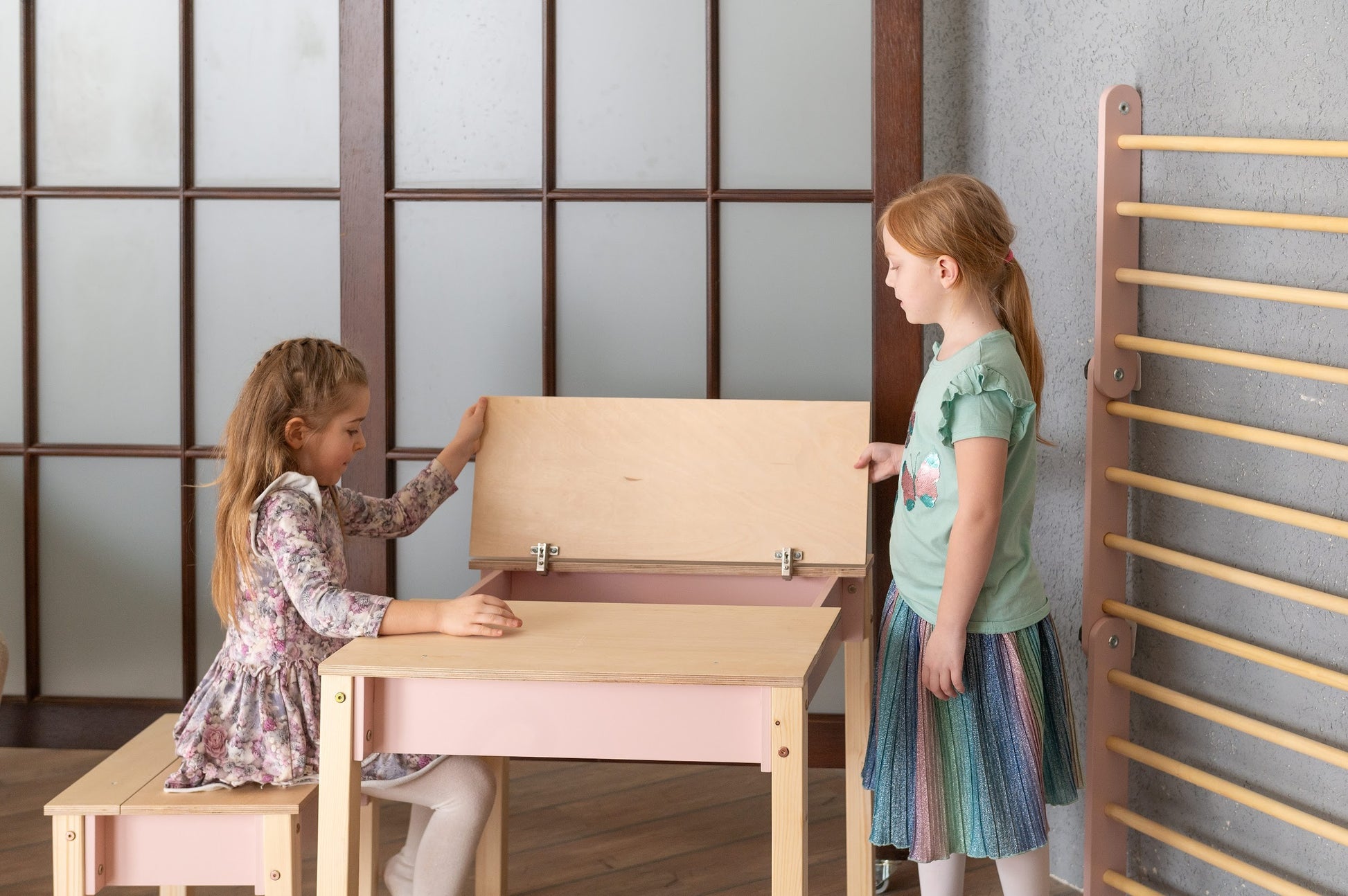 a functional kids table and chair set with storage in a bright playroom