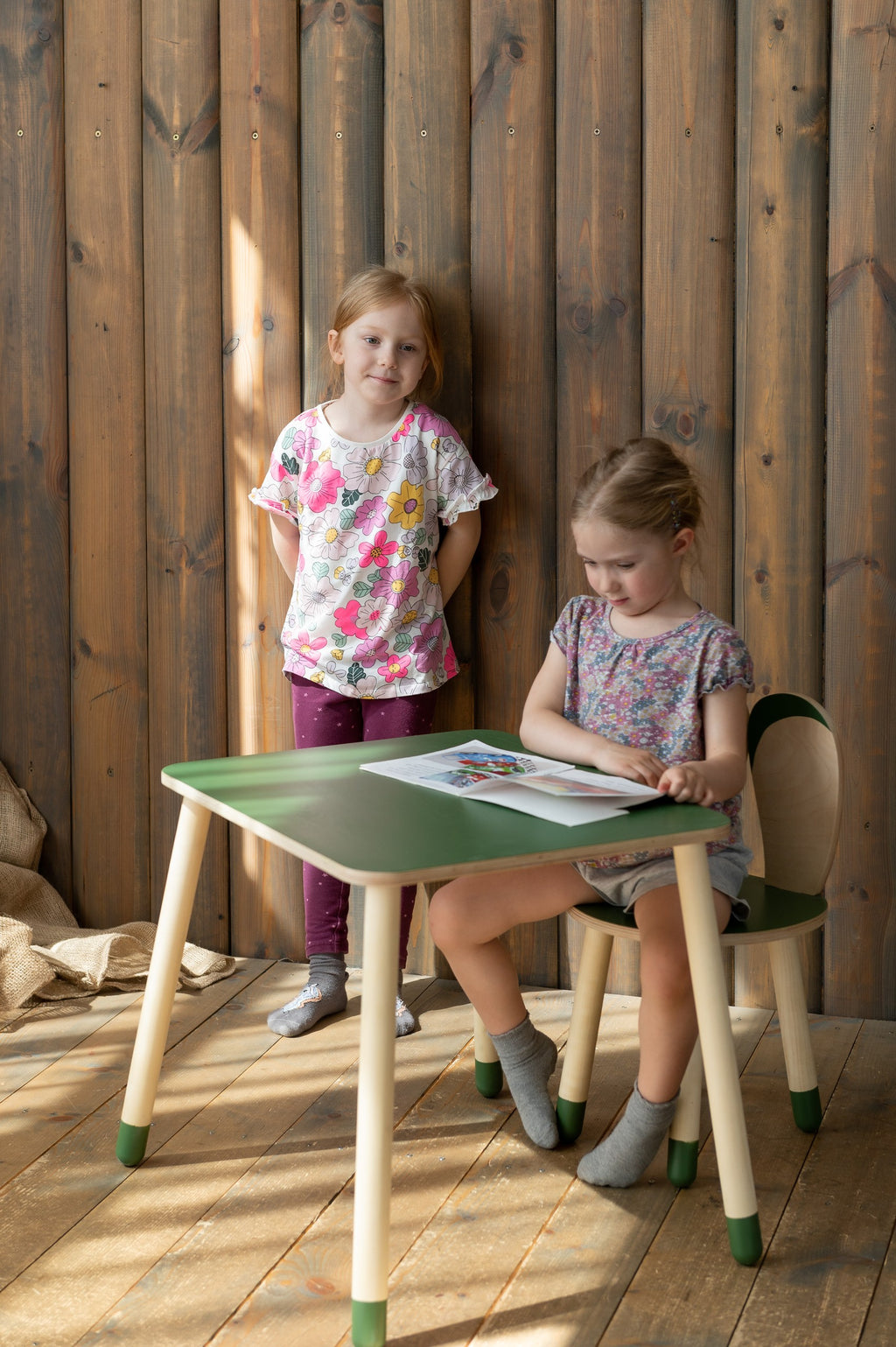 a child's hands drawing at the birch plywood bunny table set in a cozy nursery corner
