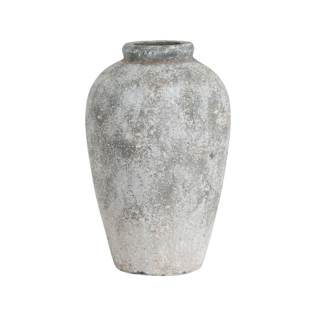 bold statement tall ceramic vase with dramatic aged stone texture in a modern living room
