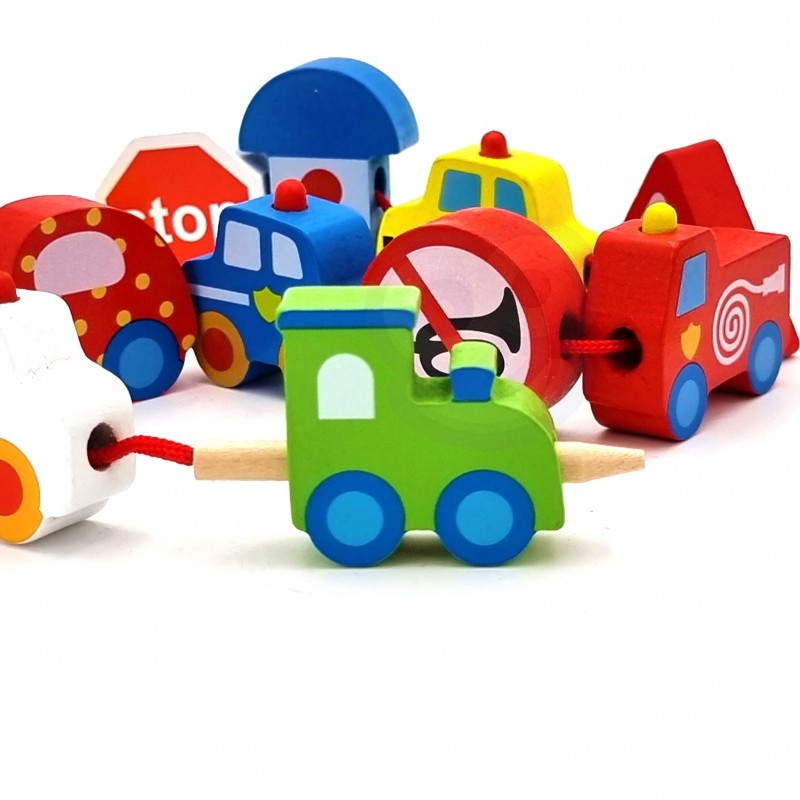 practical close-up of a child threading the wooden tractor block onto the string