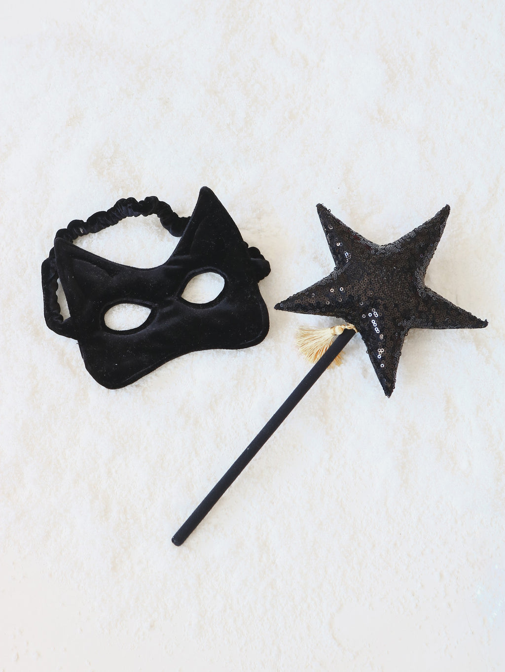 handmade black cat mask for kids with sparkling sequins on soft velvet, shown from a playful side angle