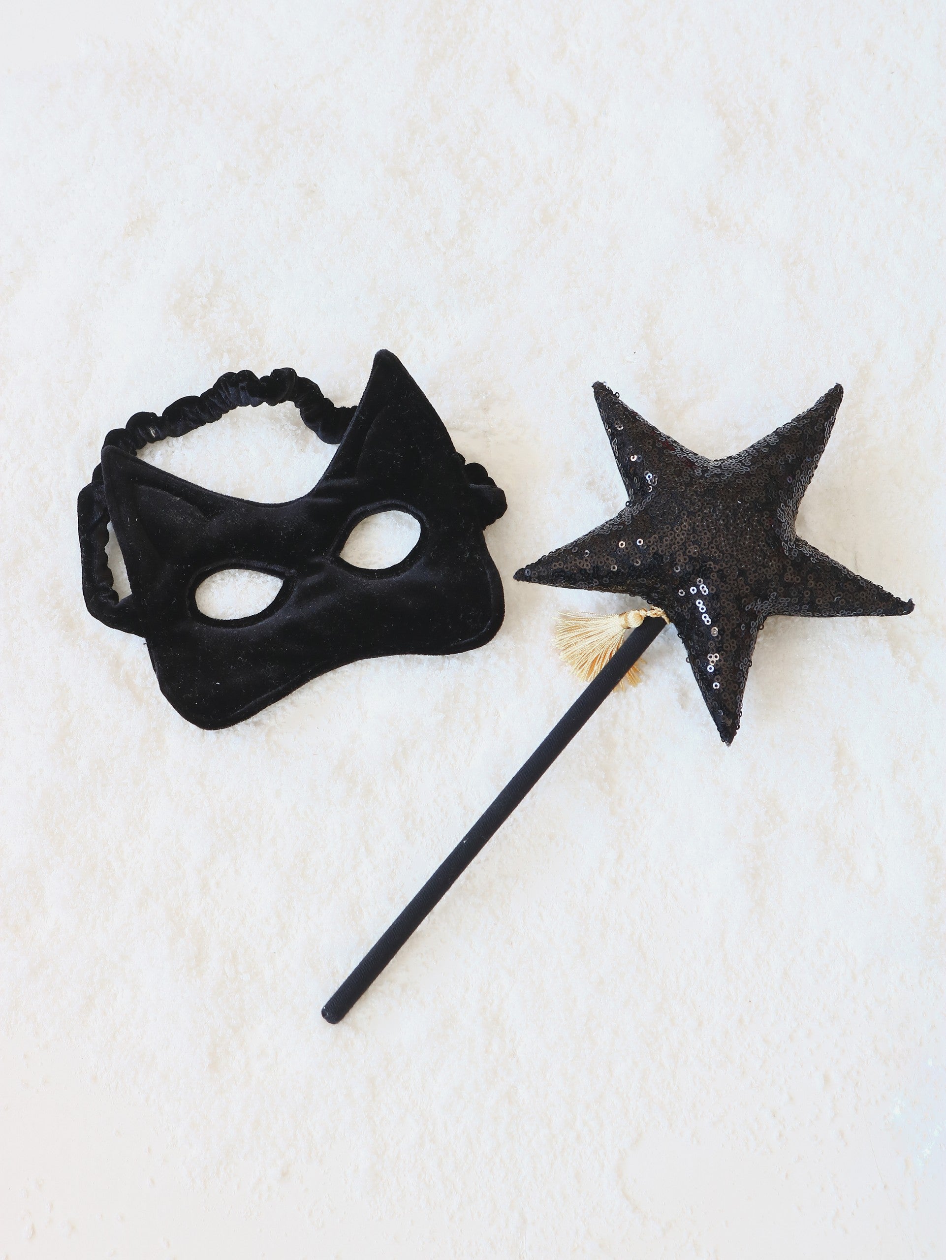 handmade black cat mask for kids with sparkling sequins on soft velvet, shown from a playful side angle