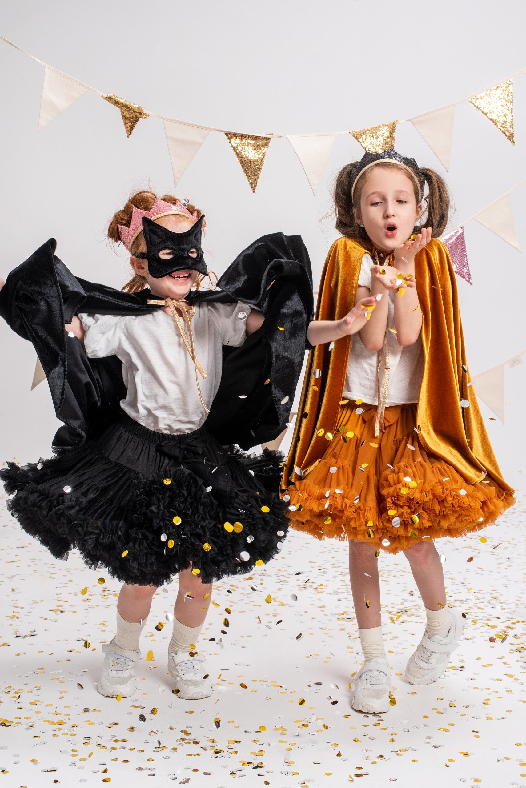 handmade black velvet cat mask for kids with shimmering sequins, side angle in soft light