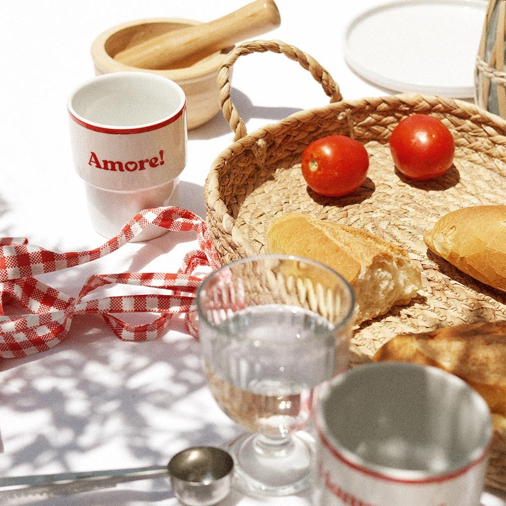 playful amore ceramic mug in warm morning light with a cappuccino