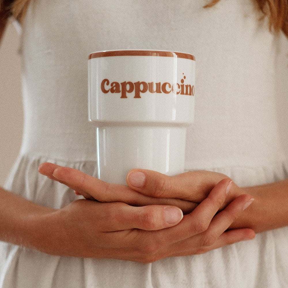 bold ceramic cappuccino mug with a rustic terra-mama design on a dark slate background