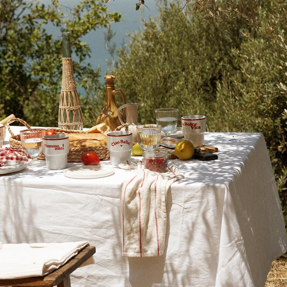 a playful ceramic mug with la dolce vita design held in sunlight, evoking italian joy