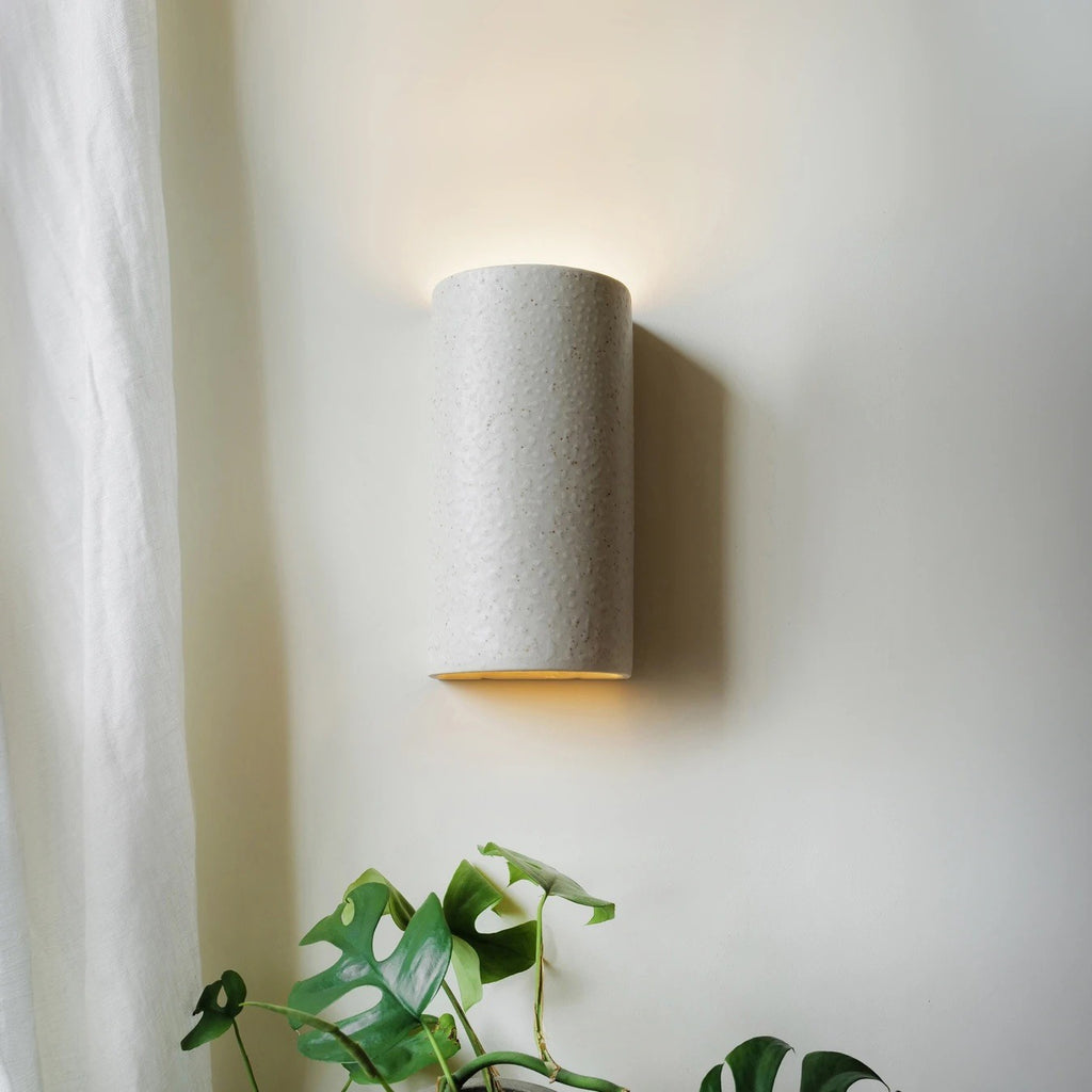 bold beige ceramic wall light with a dramatic spotted brown glaze in sharp focus