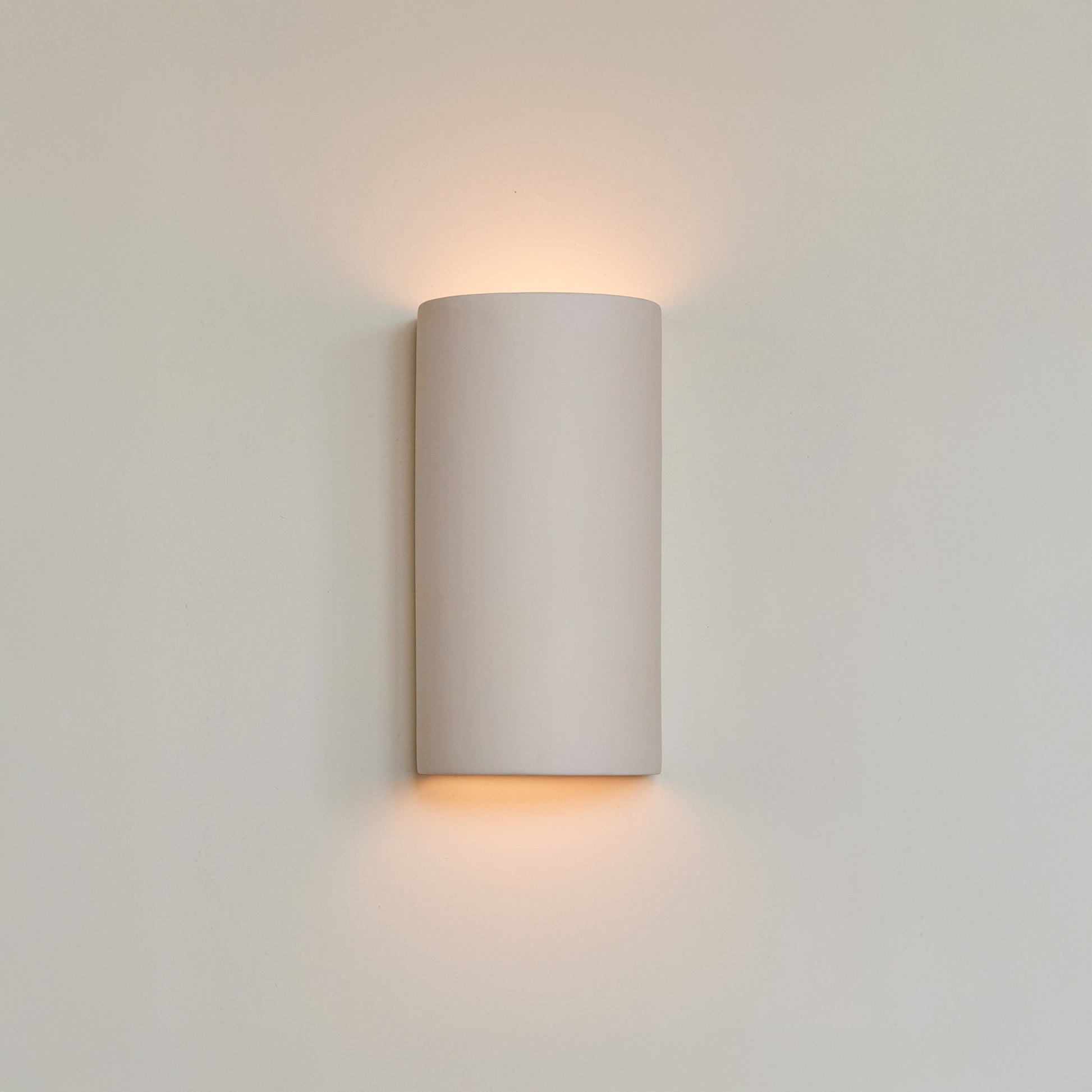a bold close-up of the handcrafted curve sconce in extra matte white, showcasing its sculptural form