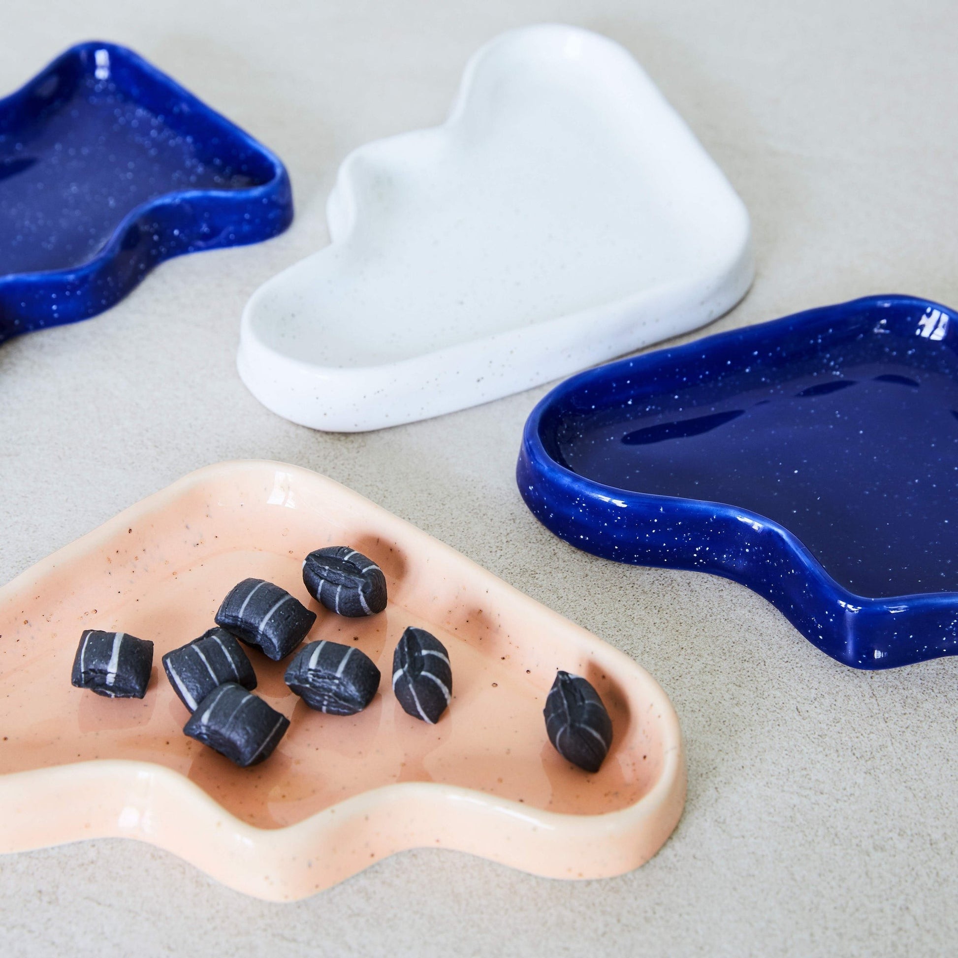 softly lit blue ceramic wave tray on a cozy linen tablecloth