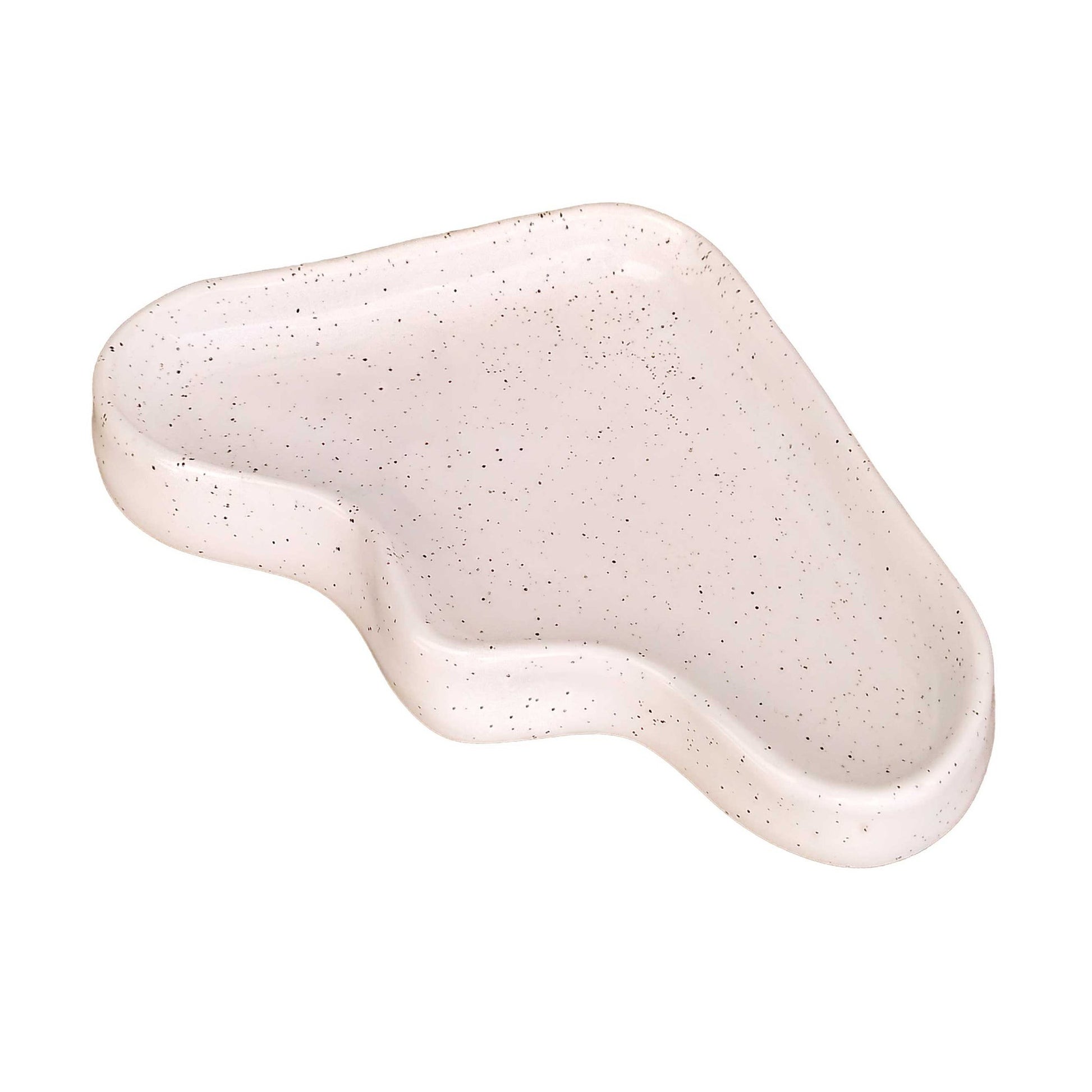 a playful speckled white ceramic triangle tray for keys on a sunny windowsill