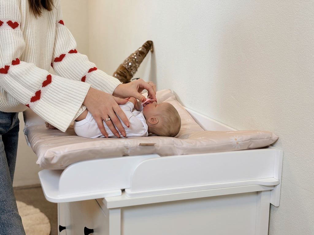 soft-lit close-up of a latvian-crafted changing mat in a serene nursery setting
