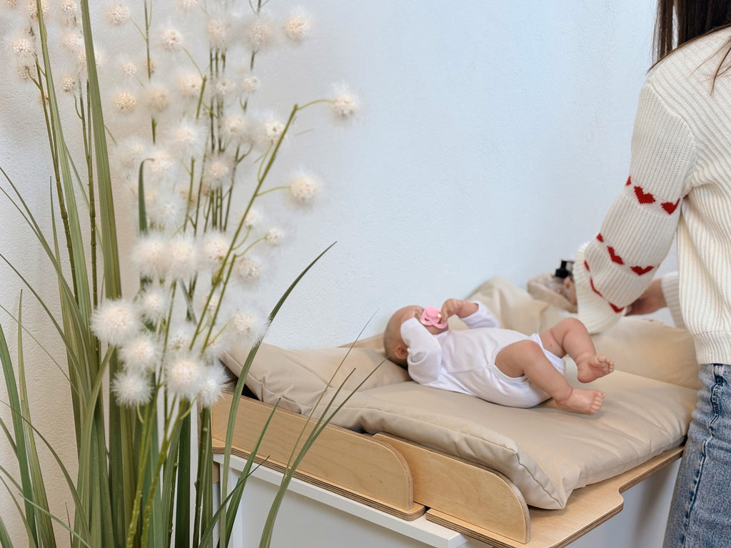 latvian-made changing mat on a table top, showcasing its lightweight 0.5kg build and 40x79cm practical dimensions