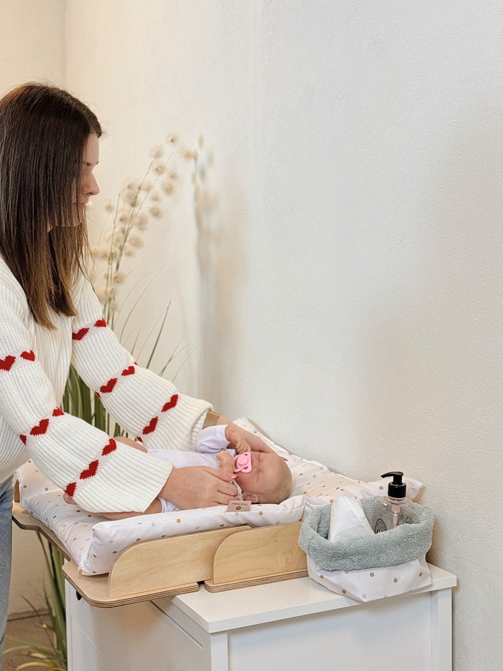 elegant latvian-crafted nursery storage basket on a changing table with soft morning light