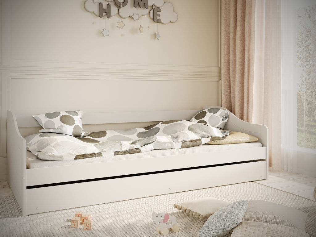 softly lit white childrens bed with open shelves and drawers for cozy organization