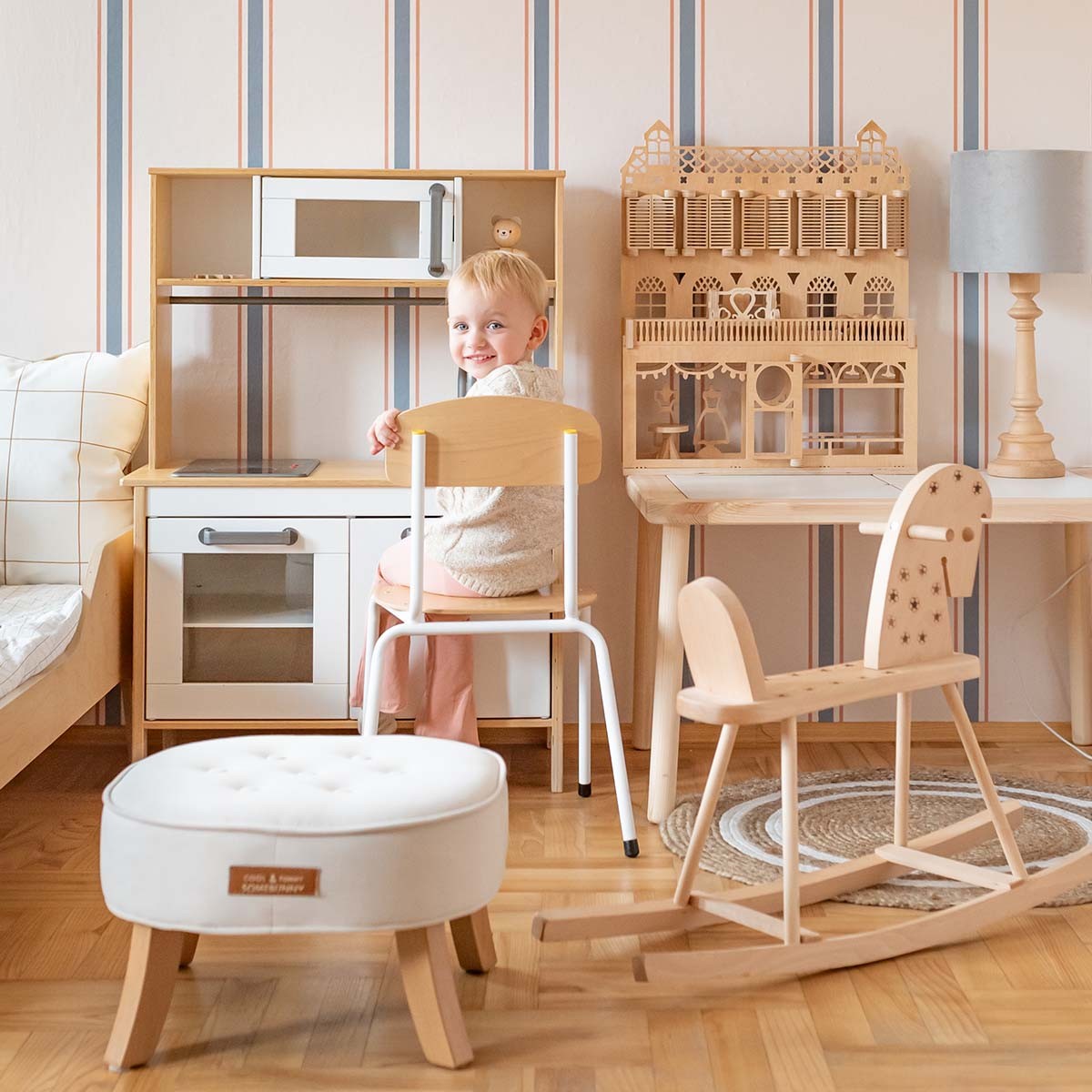 elegant linen beige and soft blue striped wallpaper in a refined nursery setting