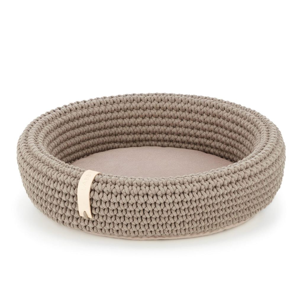 a playful cat peeking from the cozy light brown coco cotton rope bed