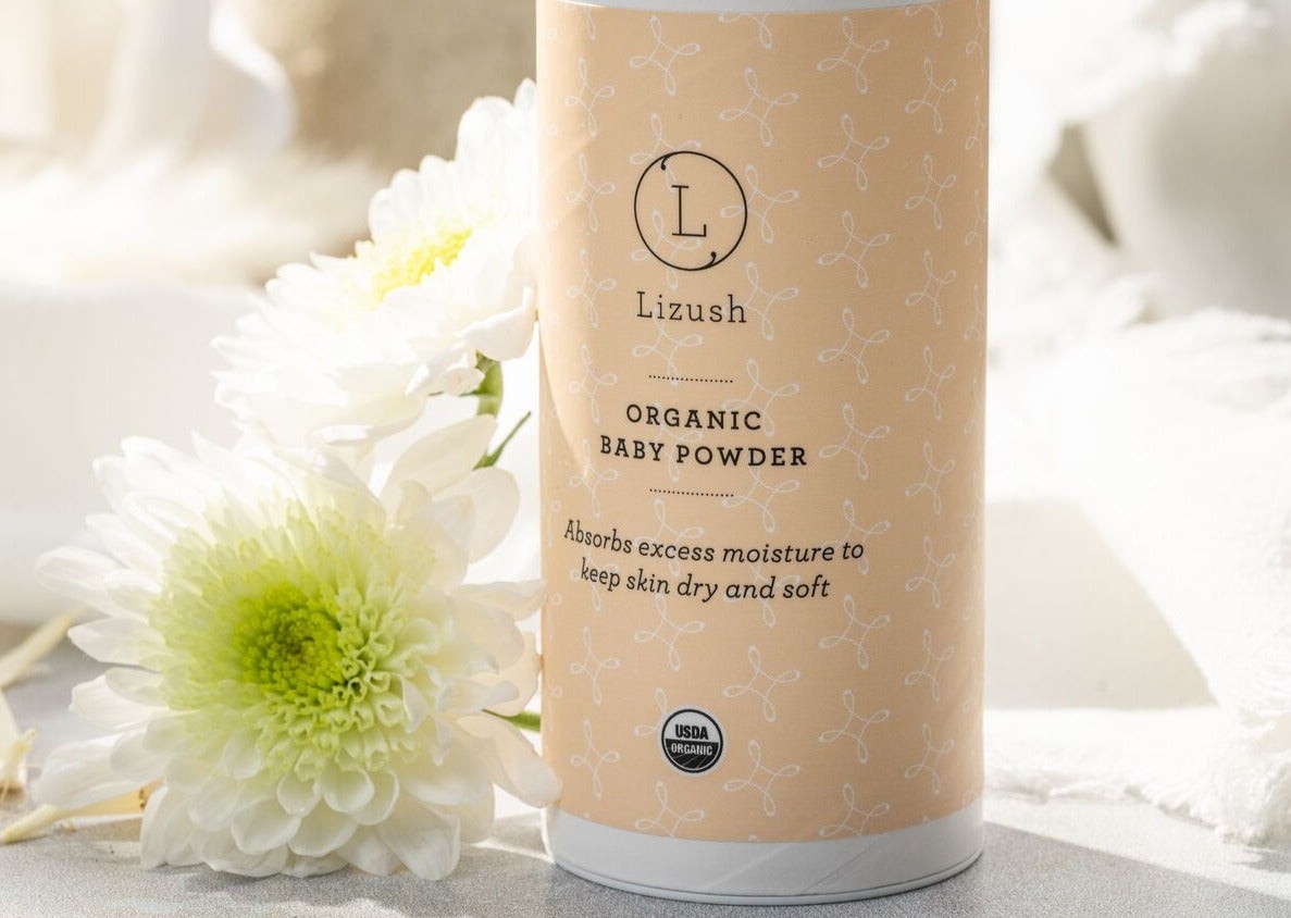 elegant close-up of organic baby powder with calendula oil on a marble surface