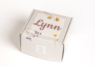 playful close-up of a dribble bib and organic balms from a handmade baby gift set
