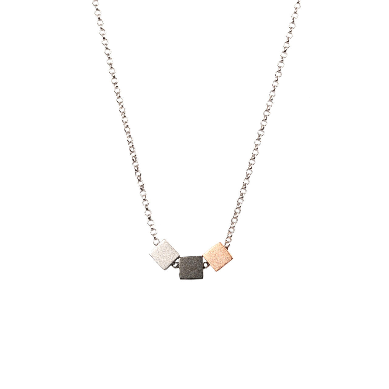 bold close-up of a minimalist satin cube choker necklace with a sharp geometric clasp