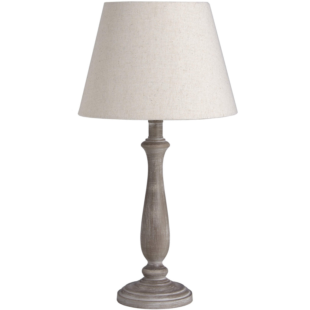 Rustic table lamp with whitewashed wood base and linen shade, warm beige tones for cozy ambient lighting. by Sostter at brixbailey.com