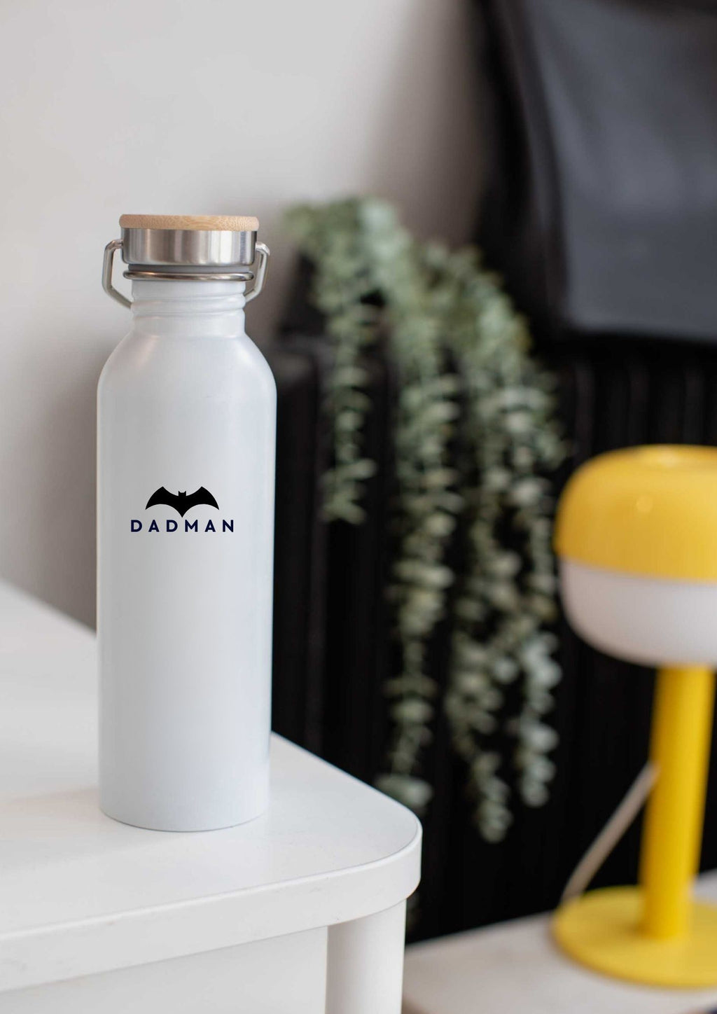 elegant black stainless steel thermos with a bamboo lid on a marble surface