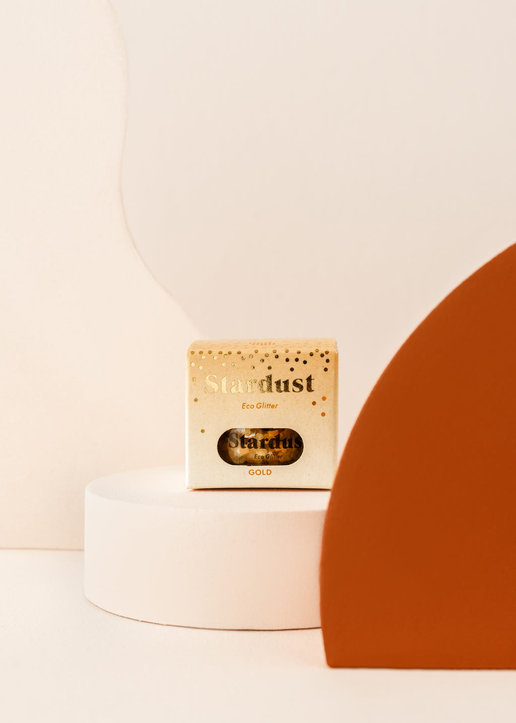 soft golden star dust glitter scattered on a wooden table, glowing warmly in natural light