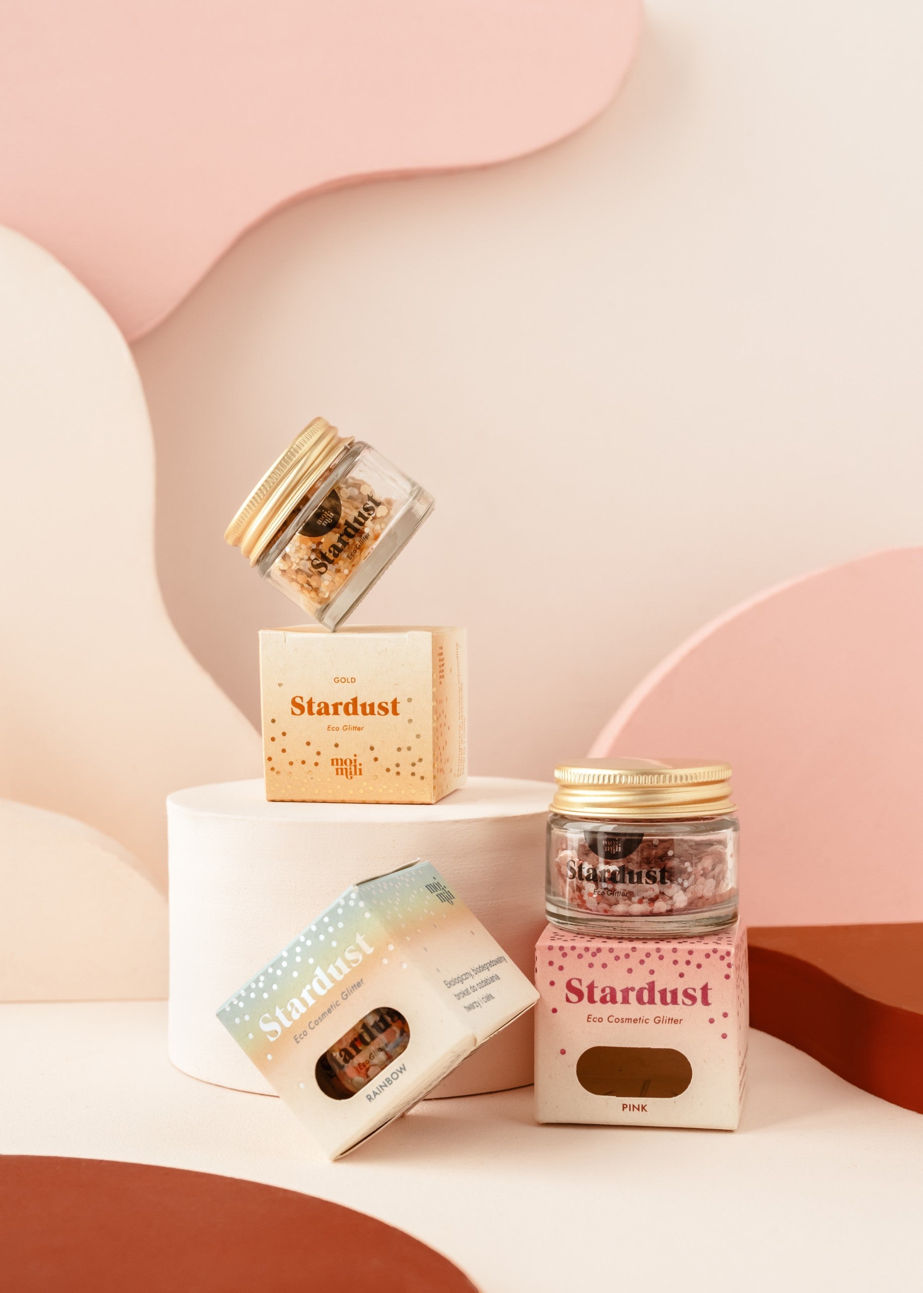 elegant glass jar of rainbow star dust eco glitter on a marble surface, catching soft light