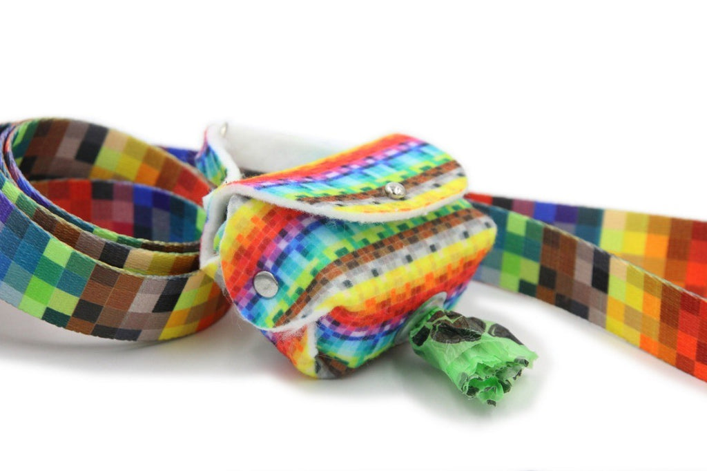 close-up of a stylish pixel-patterned felt dog waste bag dispenser in warm afternoon light