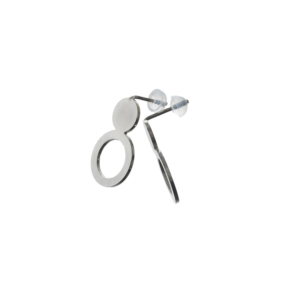 elegant silver arc earrings with a brushed finish, presented in soft light on eco velvet