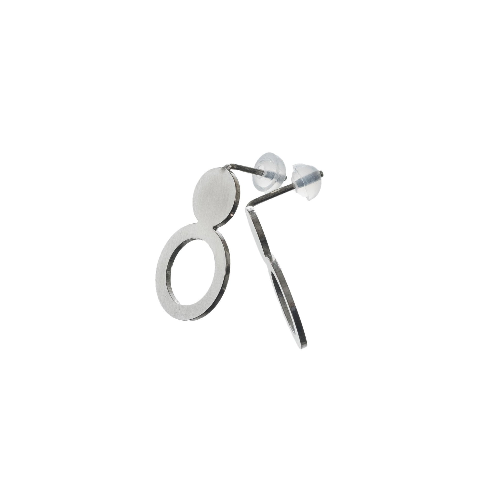 elegant silver arc earrings with a brushed finish, presented in soft light on eco velvet