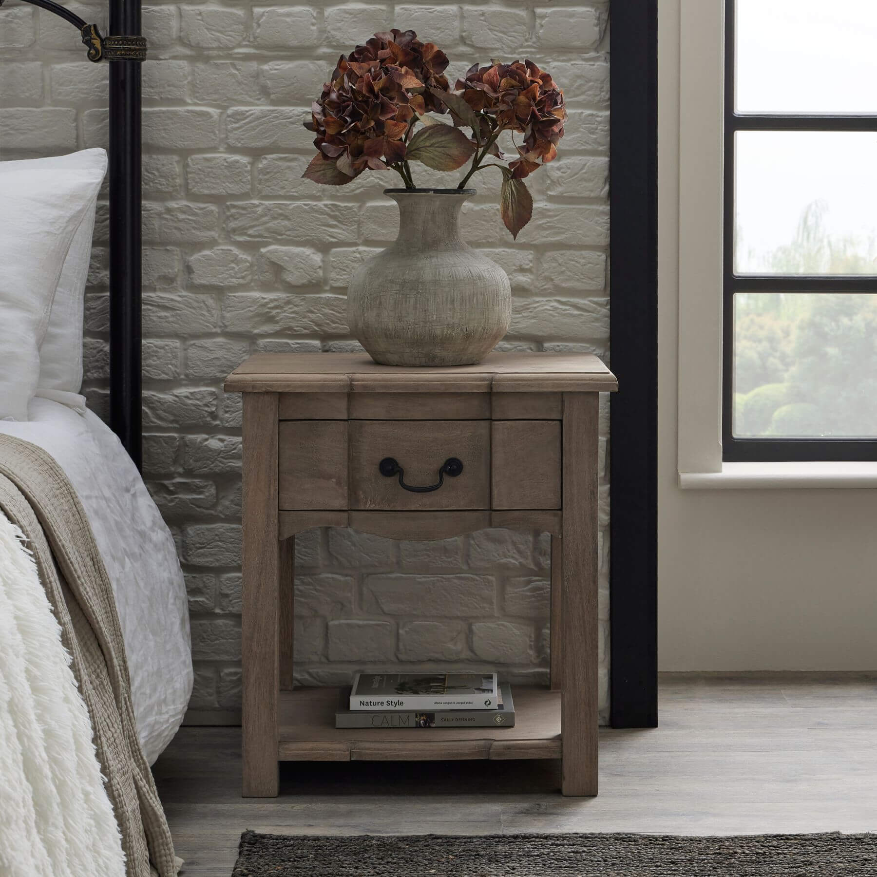 Handcrafted French provincial side table with hardwood construction, bleached wood finish, and black iron handles. by RoomLondon at brixbailey.com