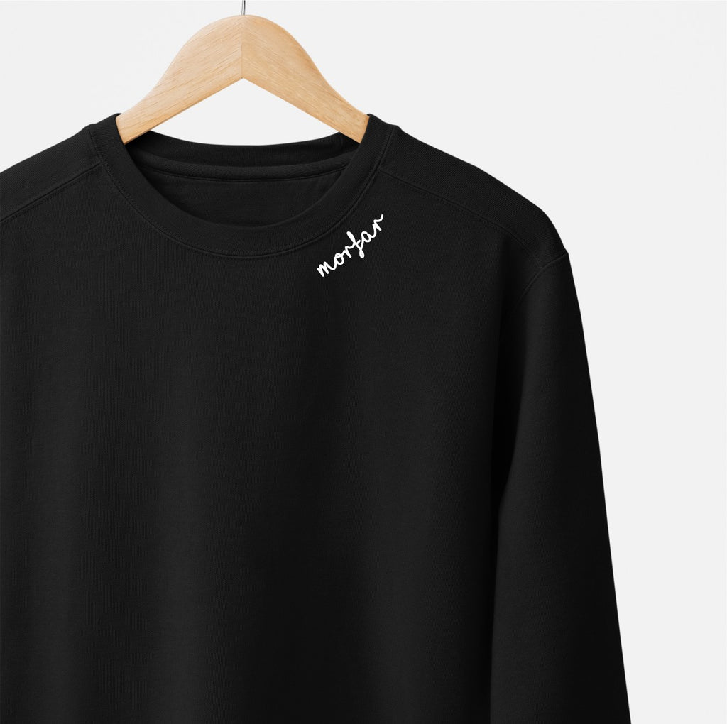 a soft beige organic cotton sweatshirt with a cozy morfar collar in warm, gentle light
