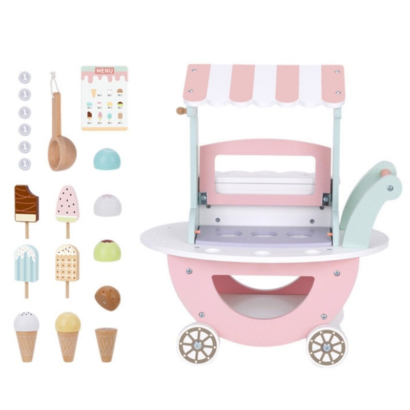 child's hand arranging colorful magnetic ice cream scoops on the pastel green cart
