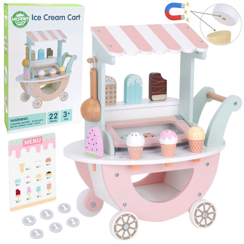 child's hand placing a magnetic ice cream scoop on a cone at the pastel green cart
