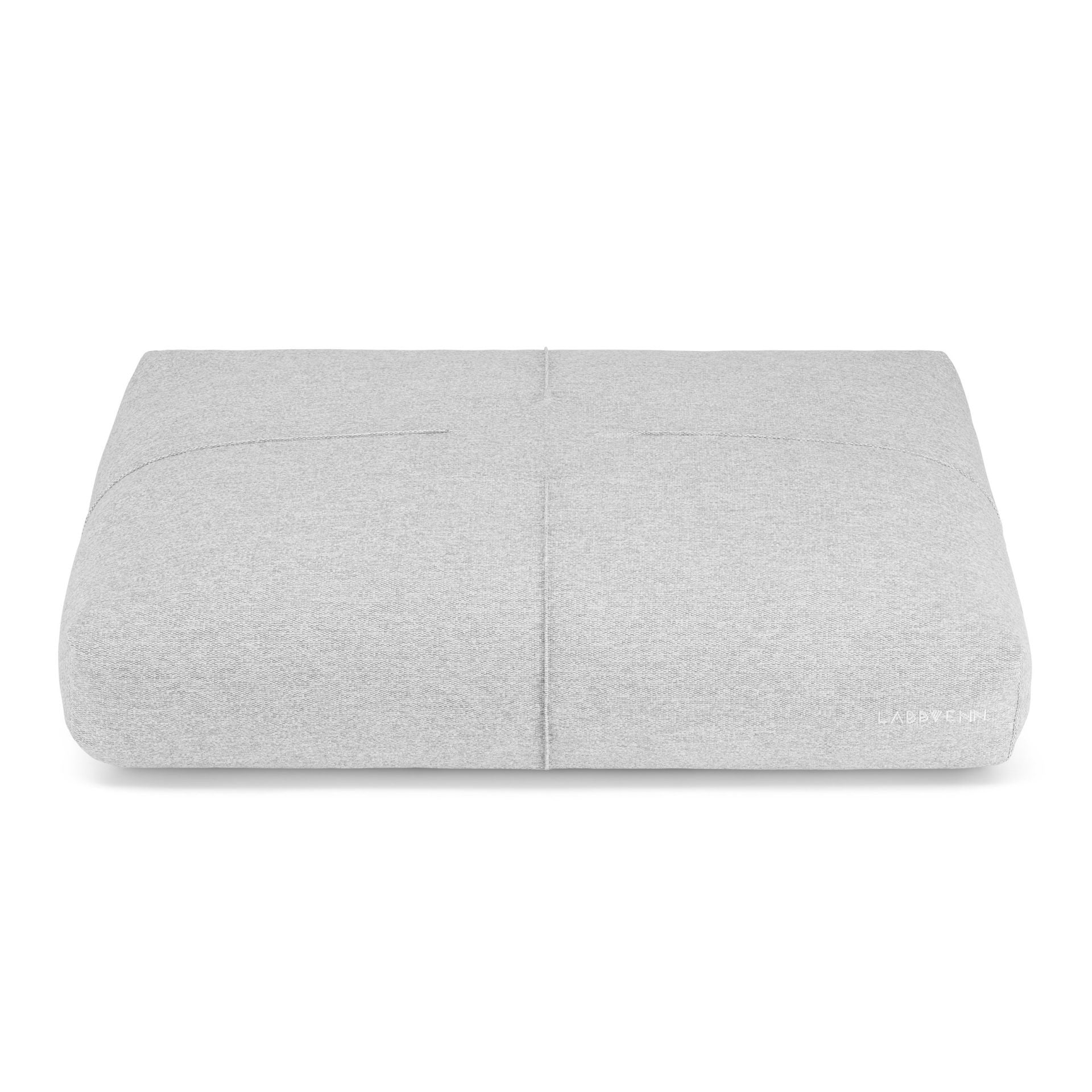 a bold statement grey finno dog cushion with elegant stitching on a dark background