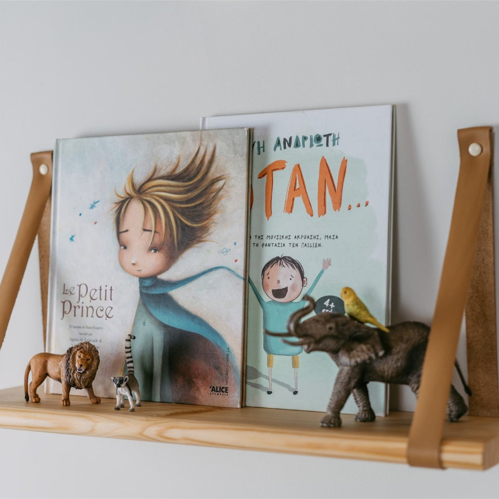 elegant floating pine shelf with camel leather straps in soft morning light