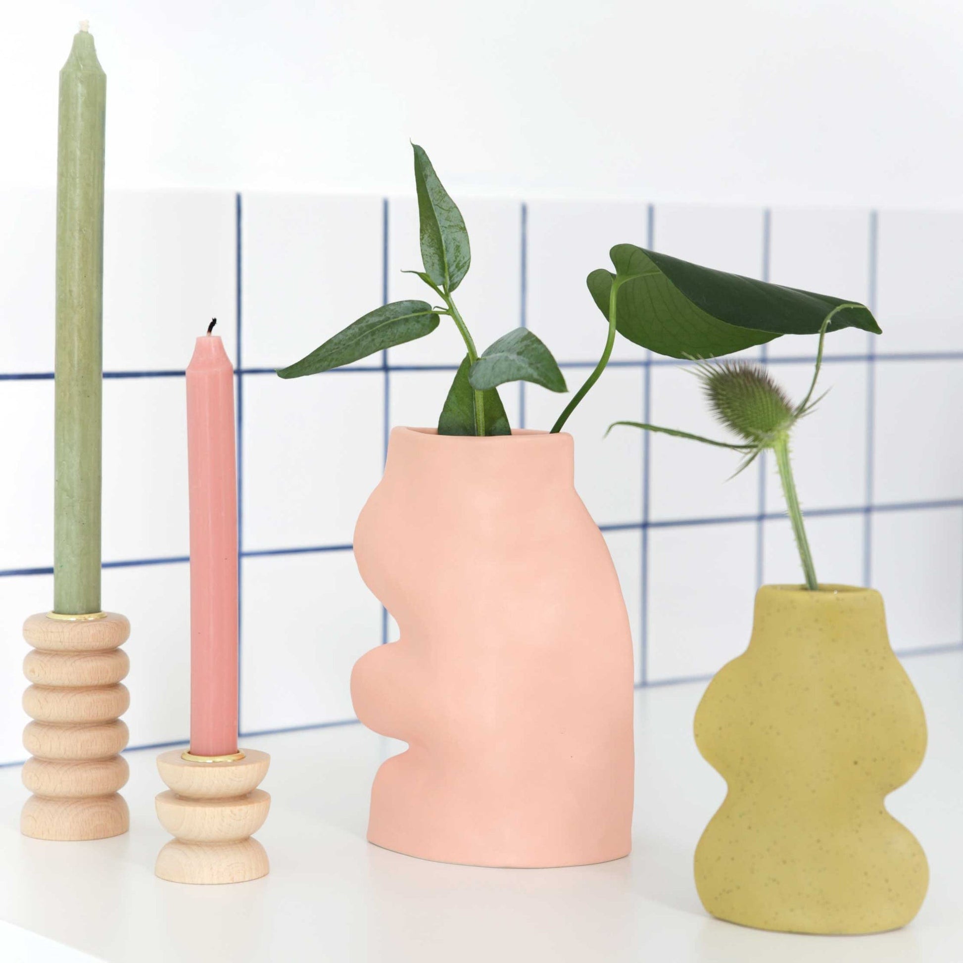 elegant pink fluxo ceramic vase on a mantel in soft morning light