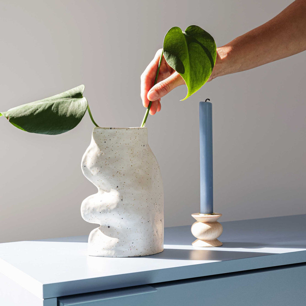 bold statement fluxo ceramic vase in dramatic studio lighting highlighting its sculptural curves
